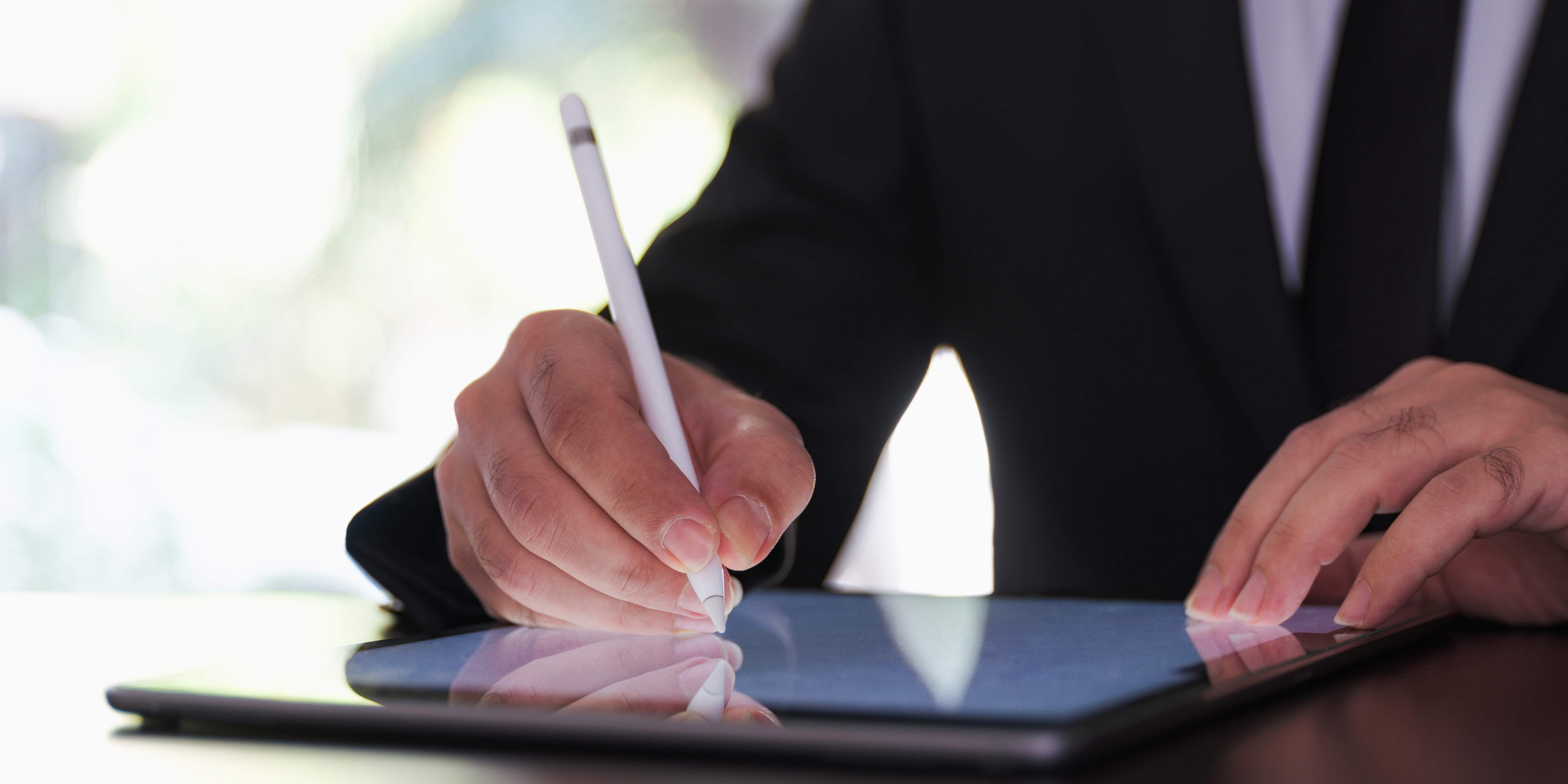 A business man signing a document electronically