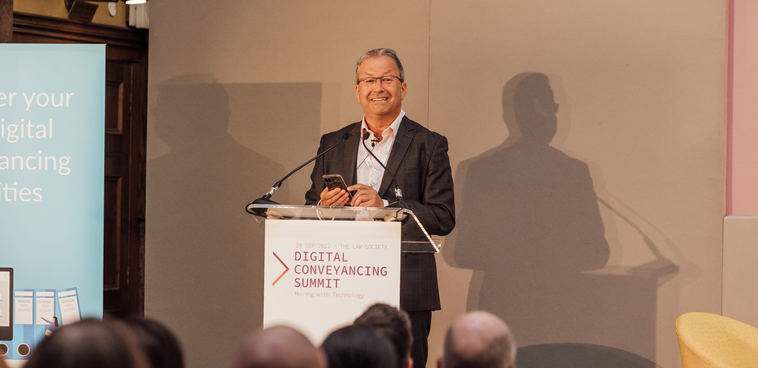 Peter Ambrose speaking behind lectern