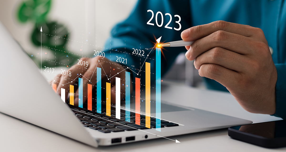 Chart imposed over laptop showing growth in 2023